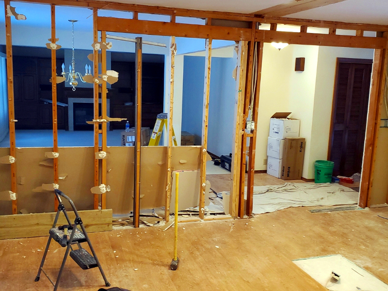 Interior remodeling process with contractor reviewing home renovation plans