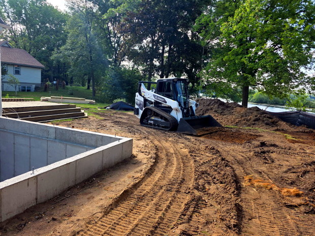 Land grading equipment leveling a property