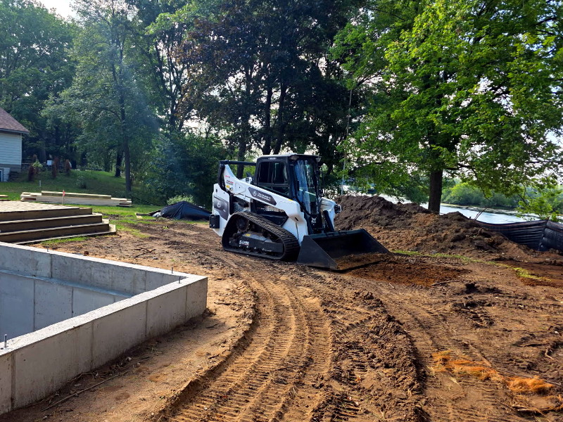 Land grading process with heavy machinery